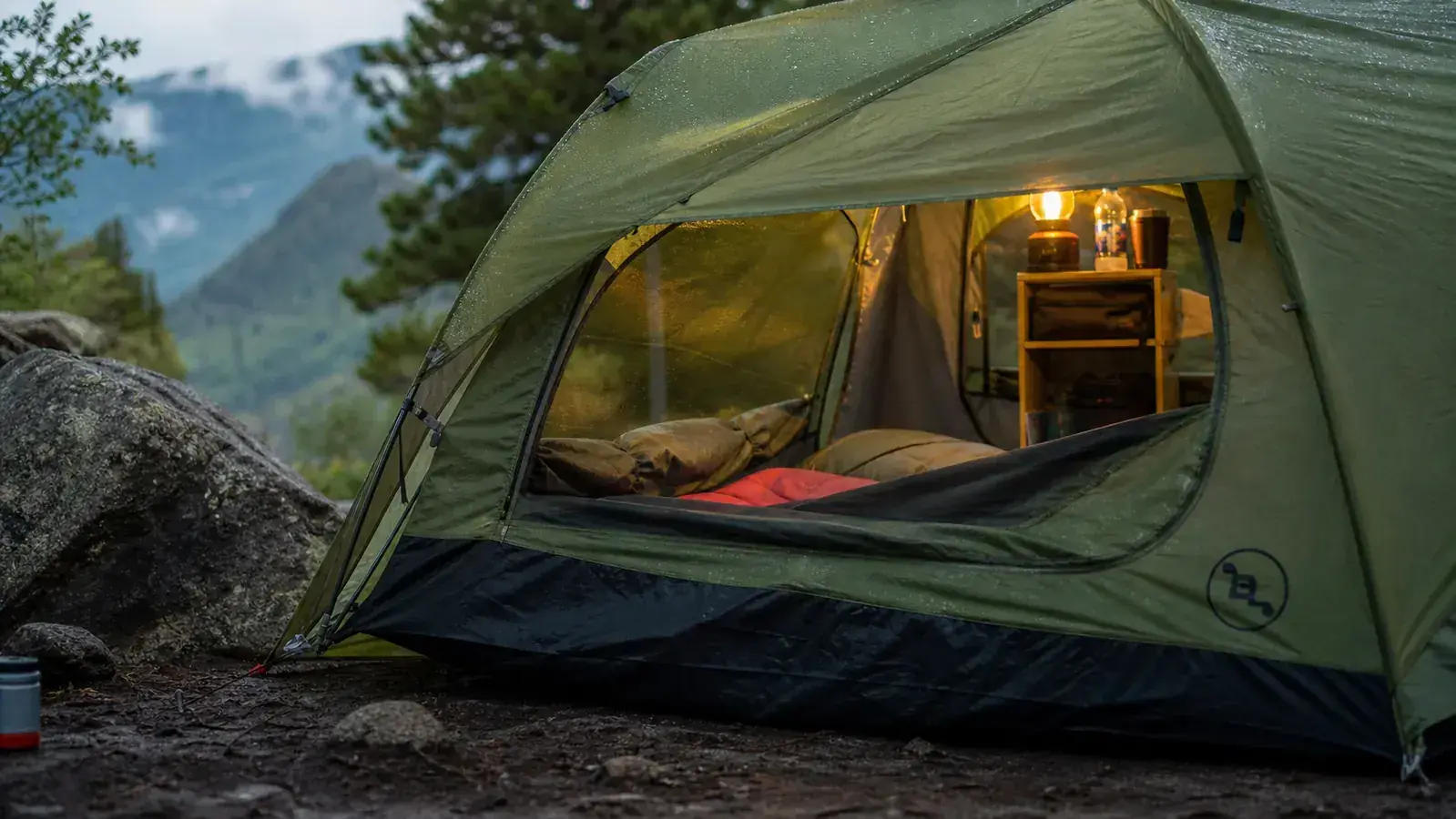 Family of four at a campsite with the Coleman Montana tent in the background, morning coffee in hand