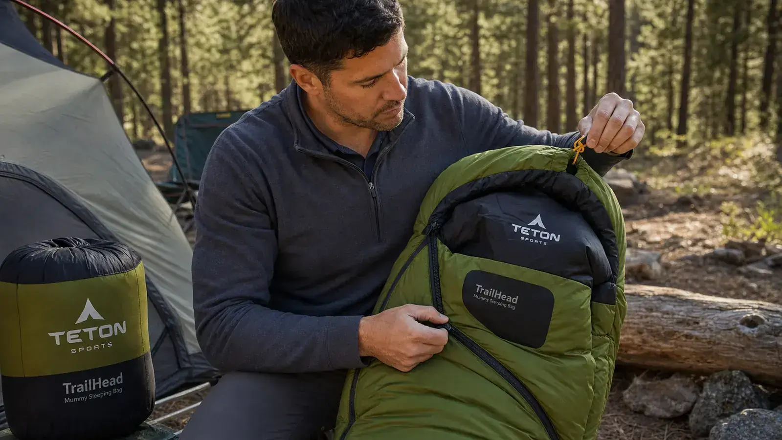 Close-up of the TETON TrailHead sleeping bag zipper and draft collar being zipped up by a person's hand
