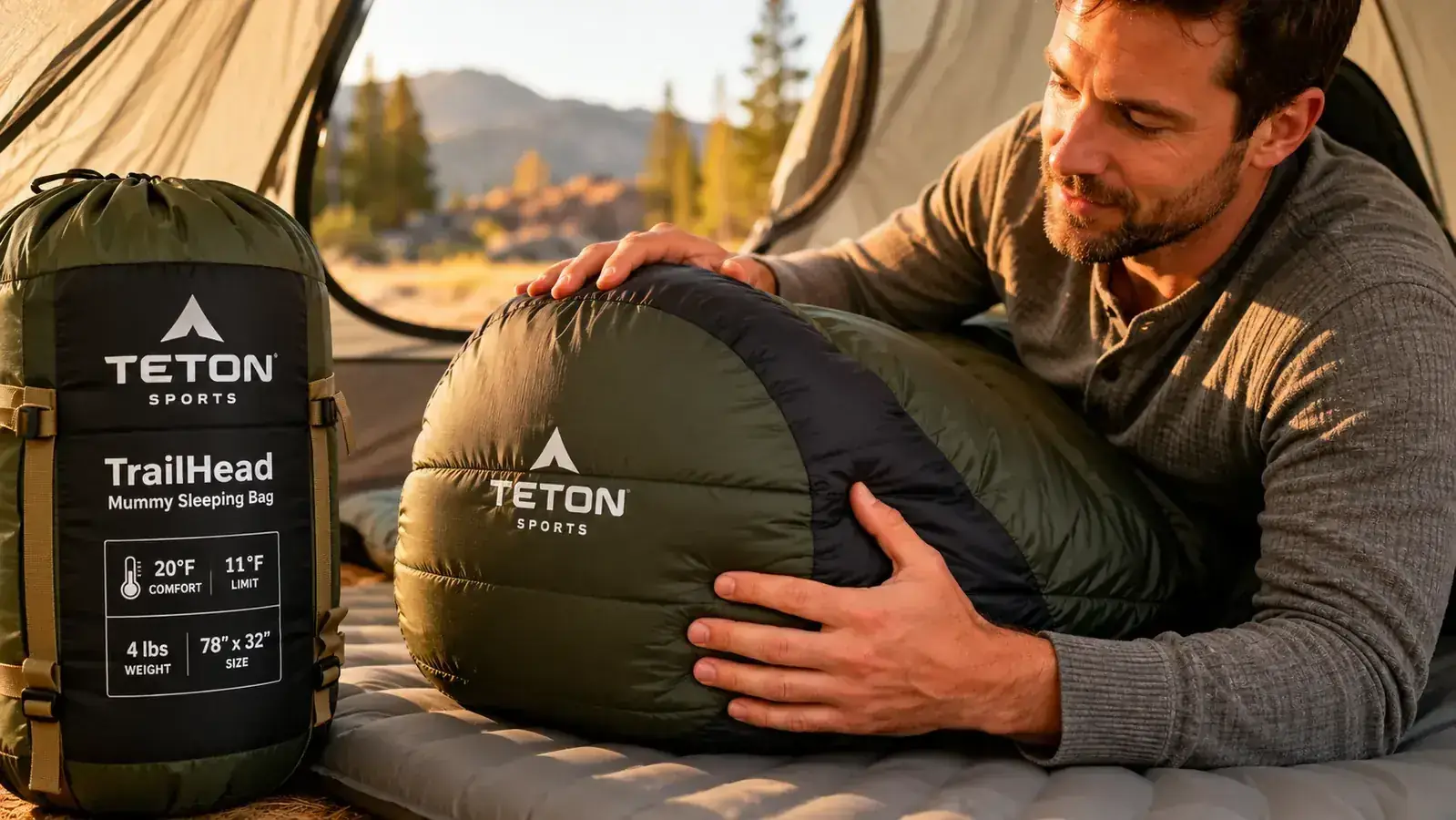 Camper stuffing the TETON TrailHead mummy bag into its compression stuff sack on a truck tailgate